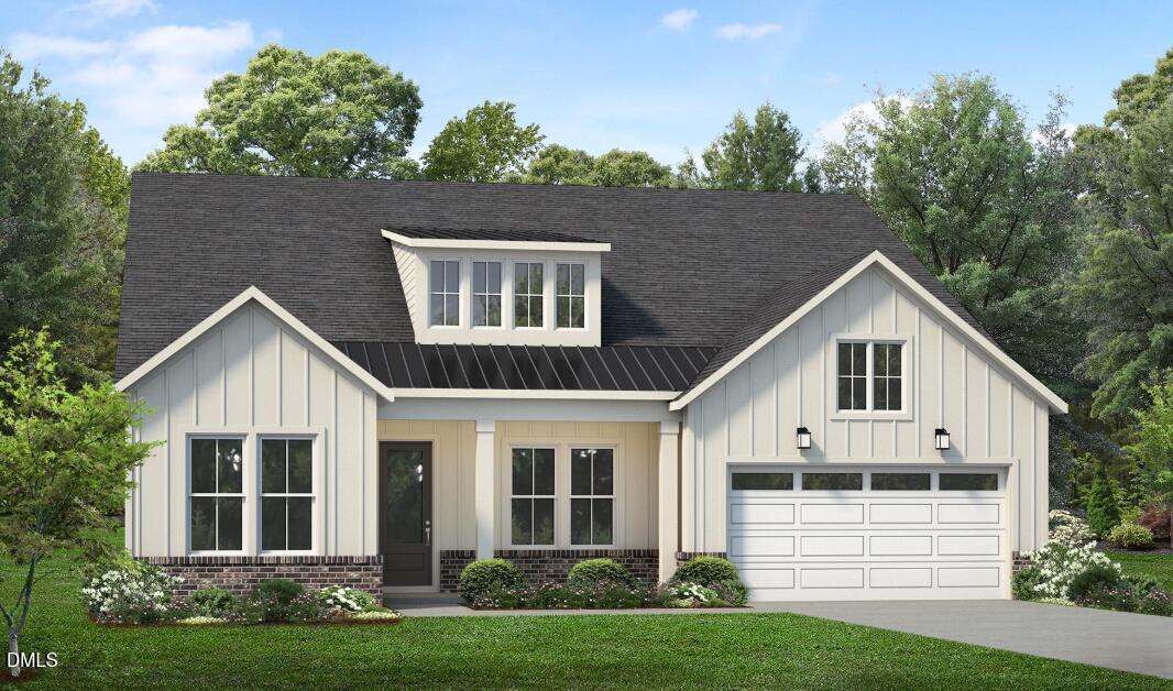 Farmhouse-style home with a front dormer, attached garage, and landscaped lawn.