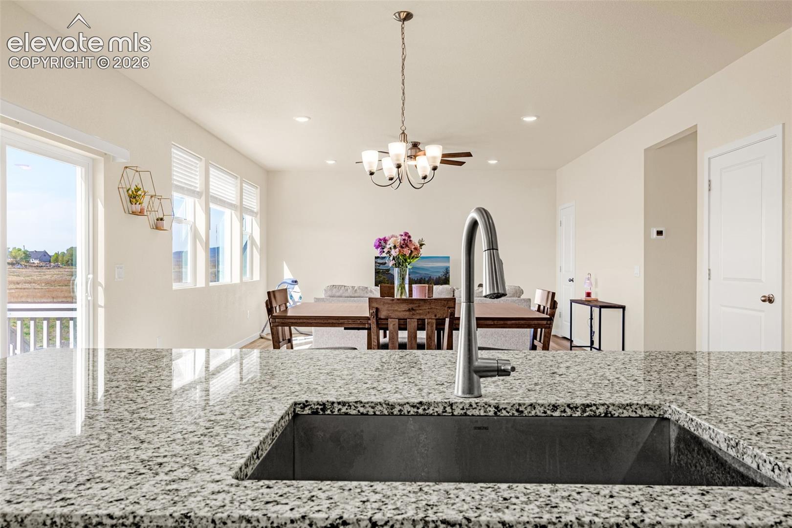 Granite-finish countertops with an undermount sink and gooseneck faucet