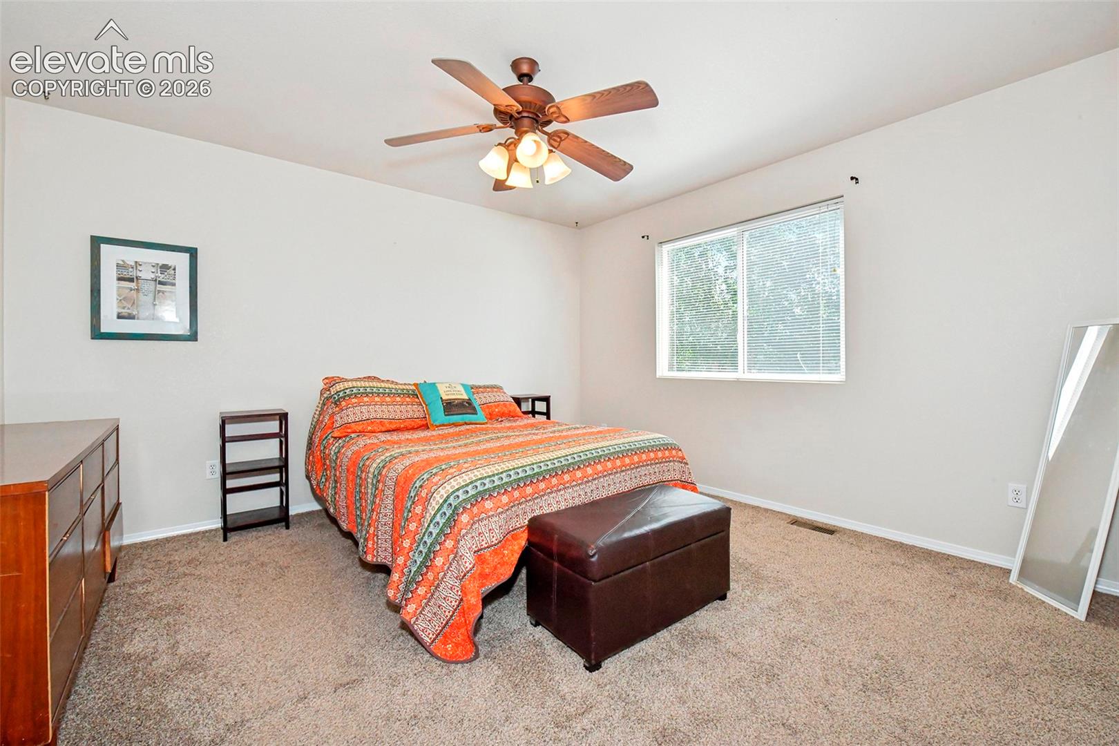 Primary bedroom with view of back yard.