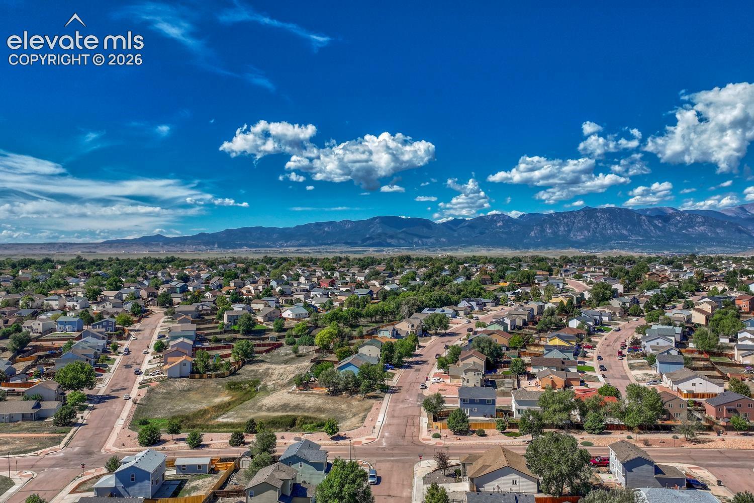 Aerial view of neighborhood and surrounding mountains.
