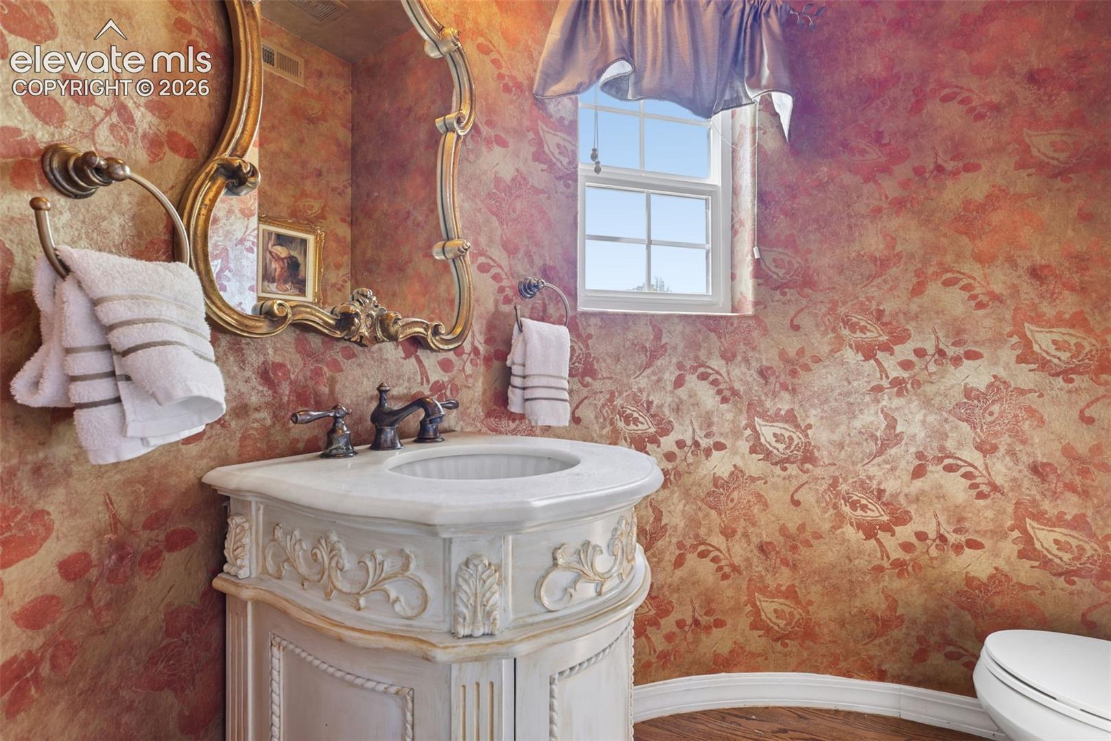 Lovely half-bath on main level in curved turret room.
