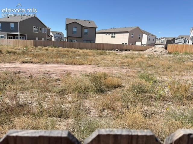 Expansive undeveloped land featuring a partial wood fence