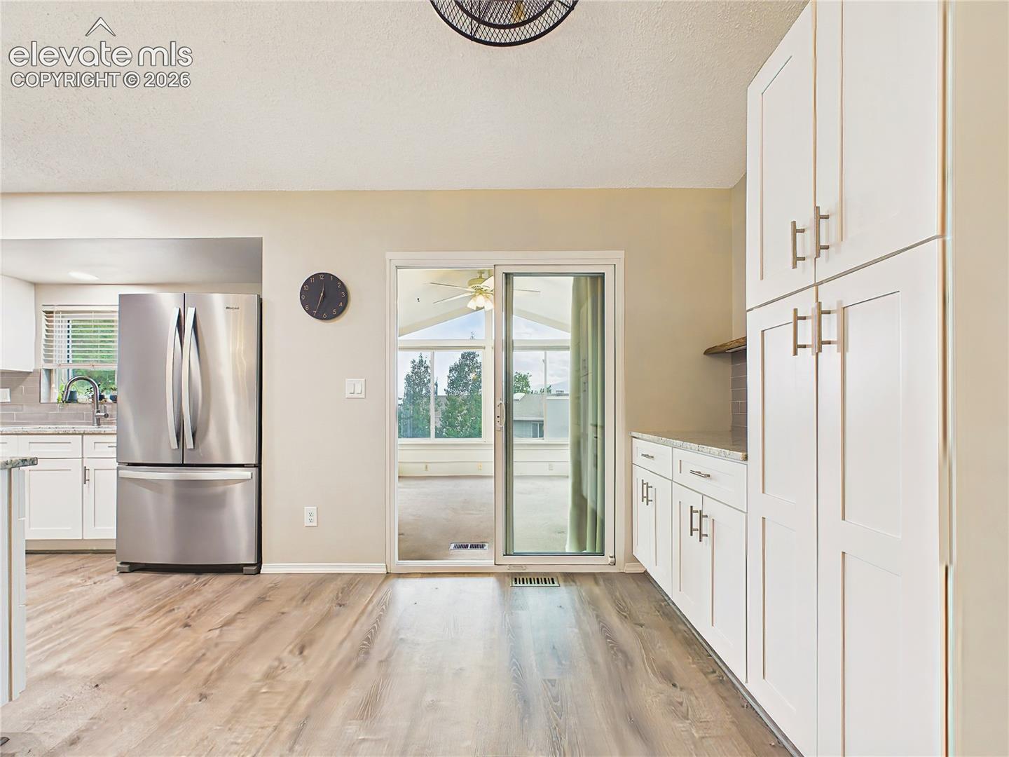 Generous pantry-style cabinetry and additional counter space provide excellent storage and functionality for meal preparation and organization.