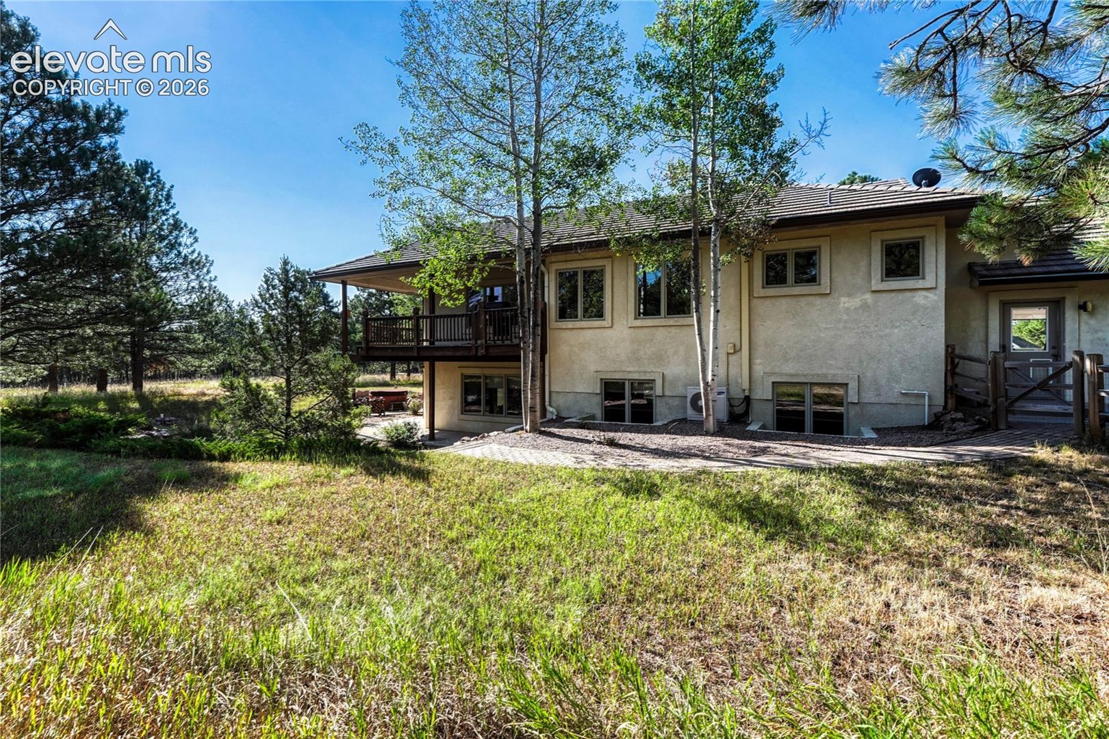 Back of the home and fenced in area for dogs.