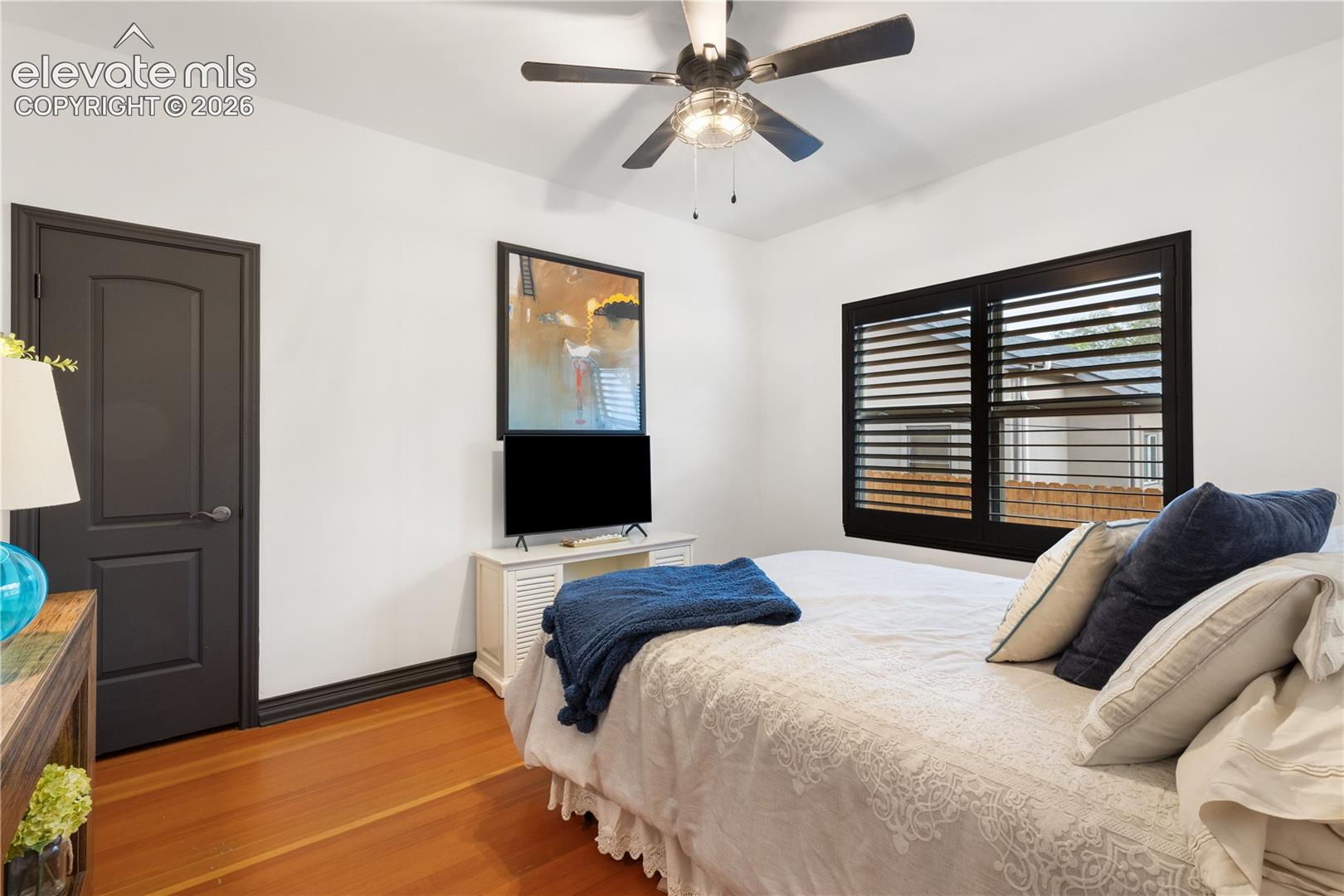 Hardwood flooring complements a neutral wall color and dark trim