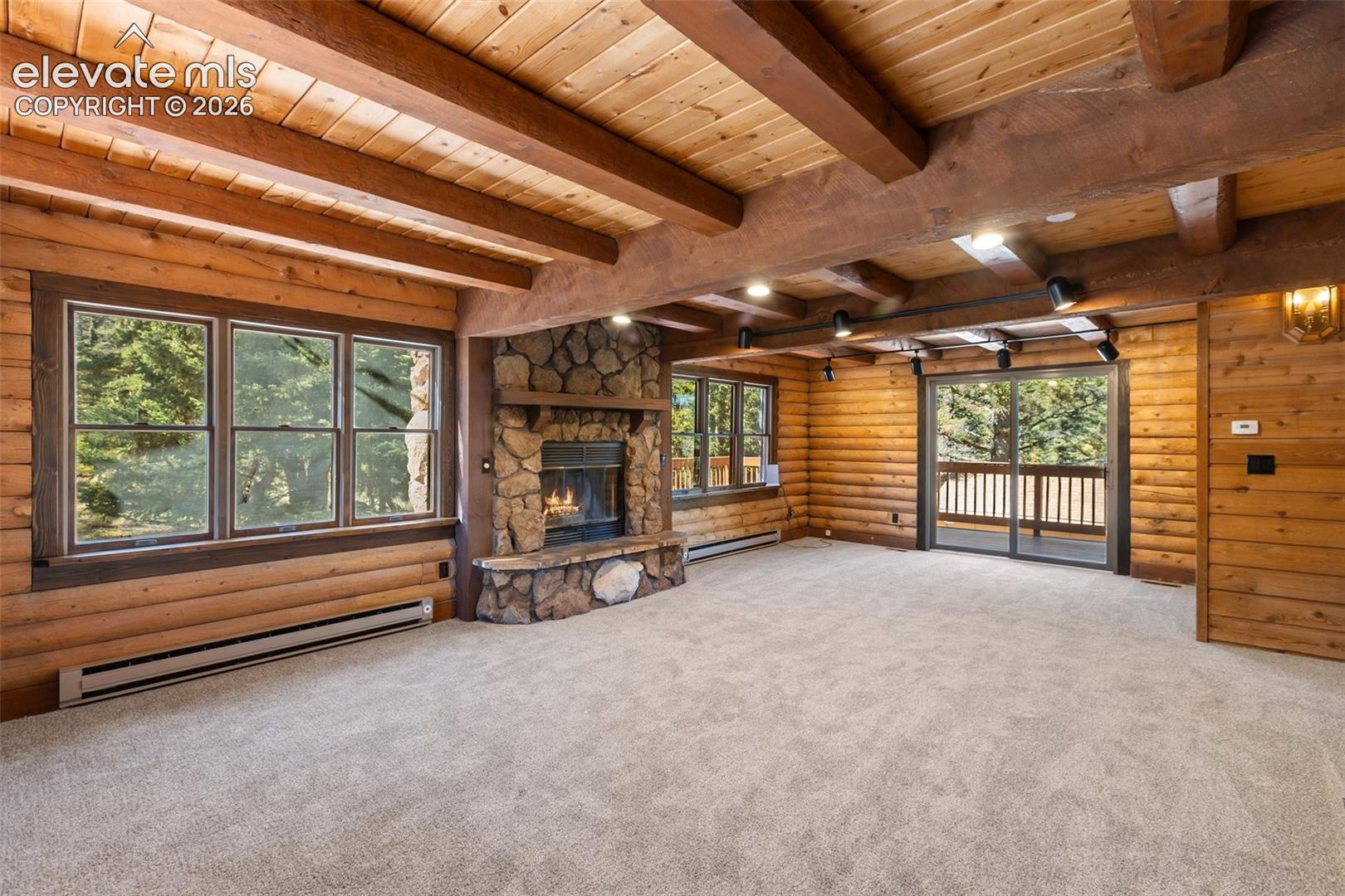Wood burning fireplace. Sliding glass door to deck. Beamed ceilings.