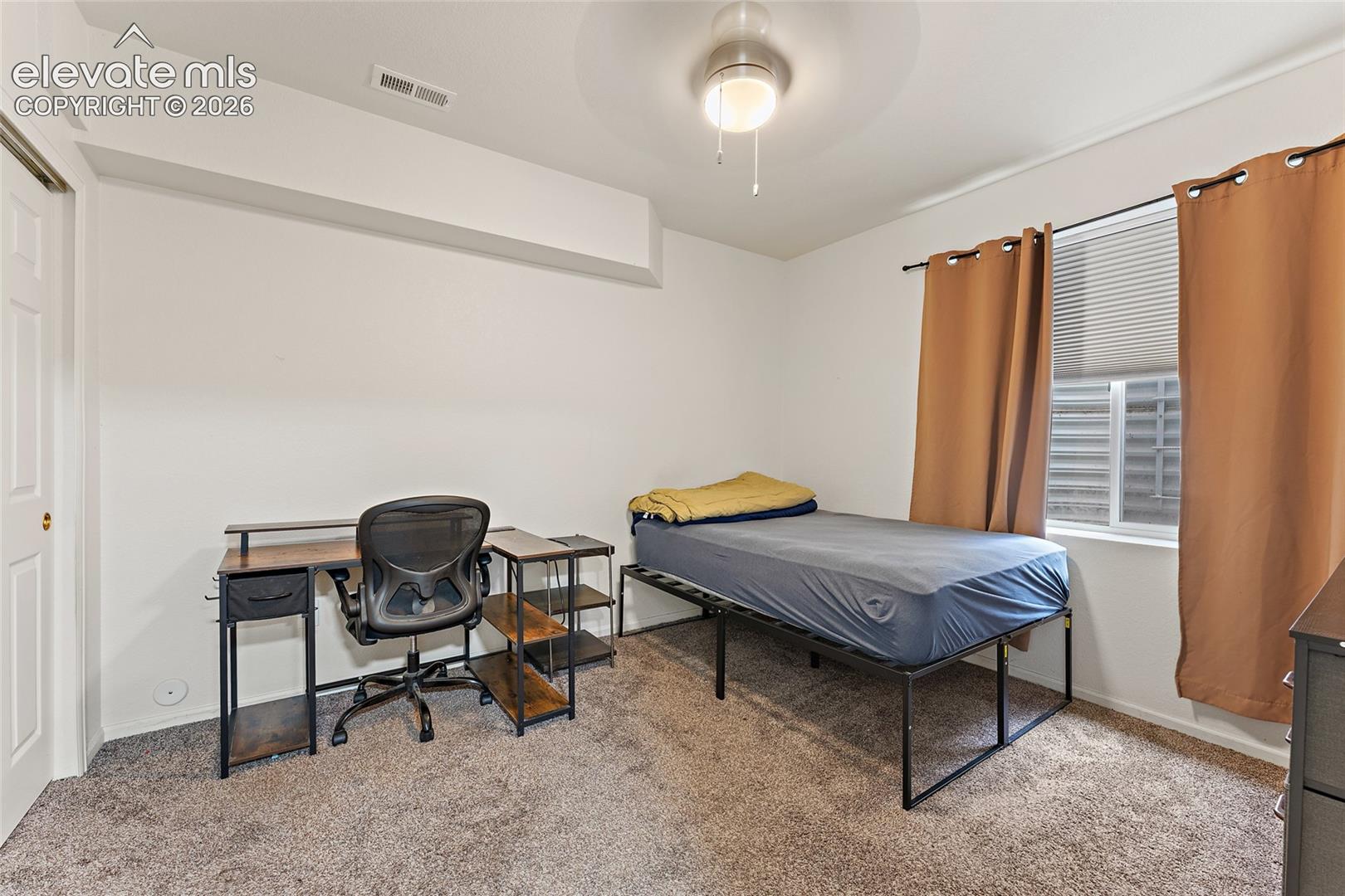 Room featuring neutral wall tones, plush wall-to-wall carpeting, and a ceiling-mounted light fixture