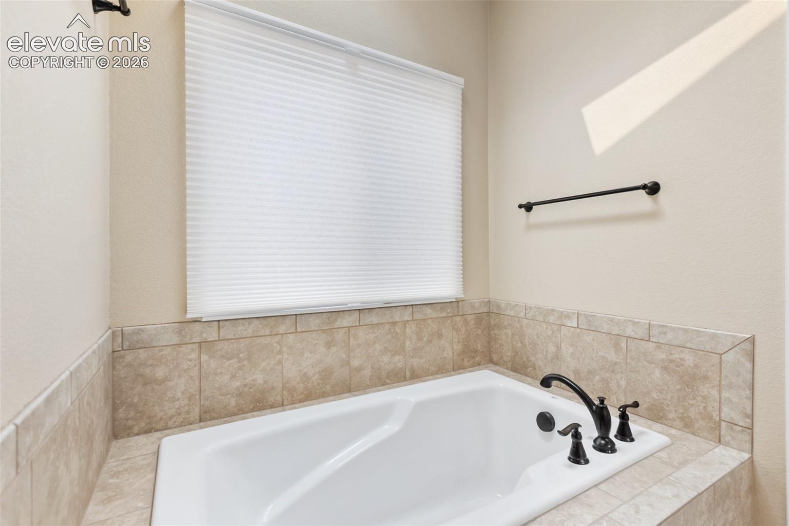 Soaking tub to relax with top down or bottom up blinds and skylight above