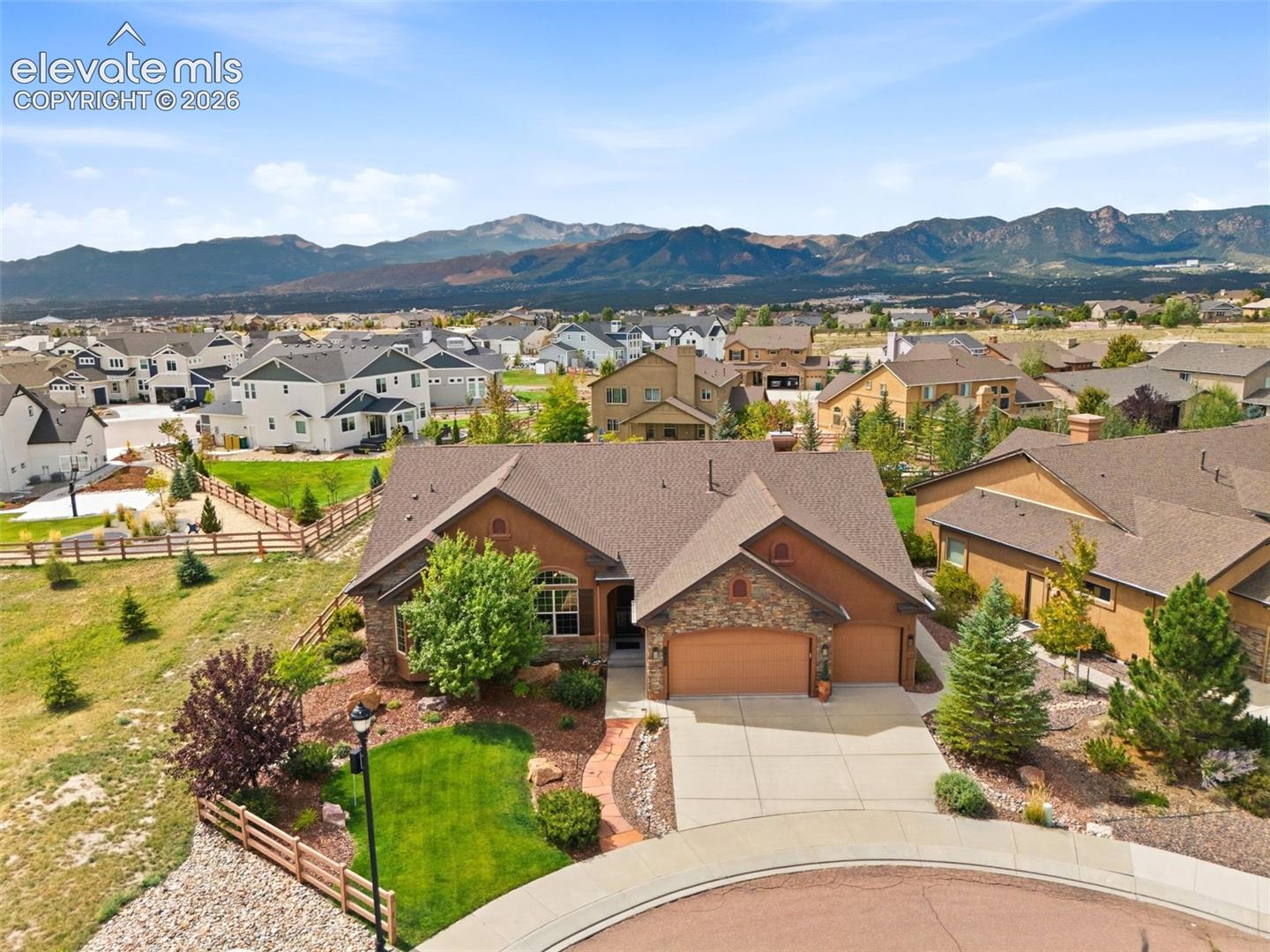 Enjoy Pikes Peak and Front Range views from this spacious home tucked away on a quiet cul-de-sac in highly desirable Flying Horse. Featuring a huge backyard, an oversized 3-car garage, and generous living spaces throughout, this home offers the perfect combination of comfort, privacy, and room to entertain.The main level features an open gourmet kitchen with stainless steel appliances, double ovens, gas range, large island, breakfast bar, pantry, custom lighting, and a dedicated coffee or beverage nook. The kitchen flows into the spacious living areas and out to the covered rear patio, where a beautiful water feature and fire pit create an ideal outdoor entertaining space.The expansive primary retreat is a standout, offering a private sitting area, 5-piece bath, and incredible views of Pikes Peak and the Front Range. Also on the main level are a private office with a double-sided fireplace, an additional bedroom and full bath, formal dining area, spacious living room, and large laundry room.The finished basement provides even more room to spread out, with a huge game and recreation area, custom wet bar, second living room, three additional bedrooms, full bath, and abundant storage. With 5 bedrooms, 3 bathrooms, 9'+ ceilings, oversized rooms, backyard fully fenced, and beautiful mountain views, this Flying Horse ranch offers exceptional space inside and out.
