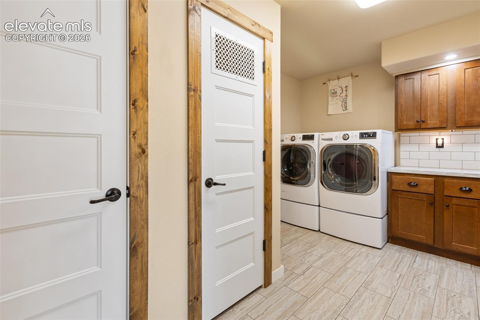 Laundry with storage cabinets and folding space. 