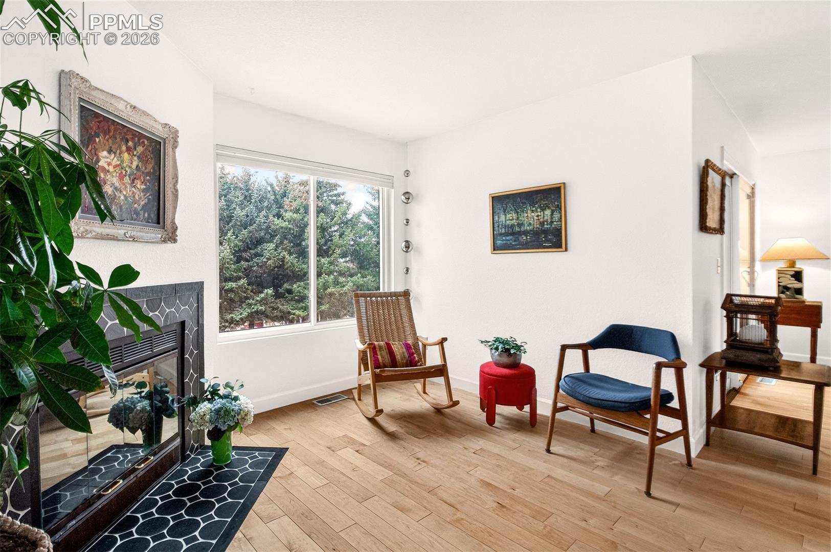 Another view of the living room and beautiful fir trees.