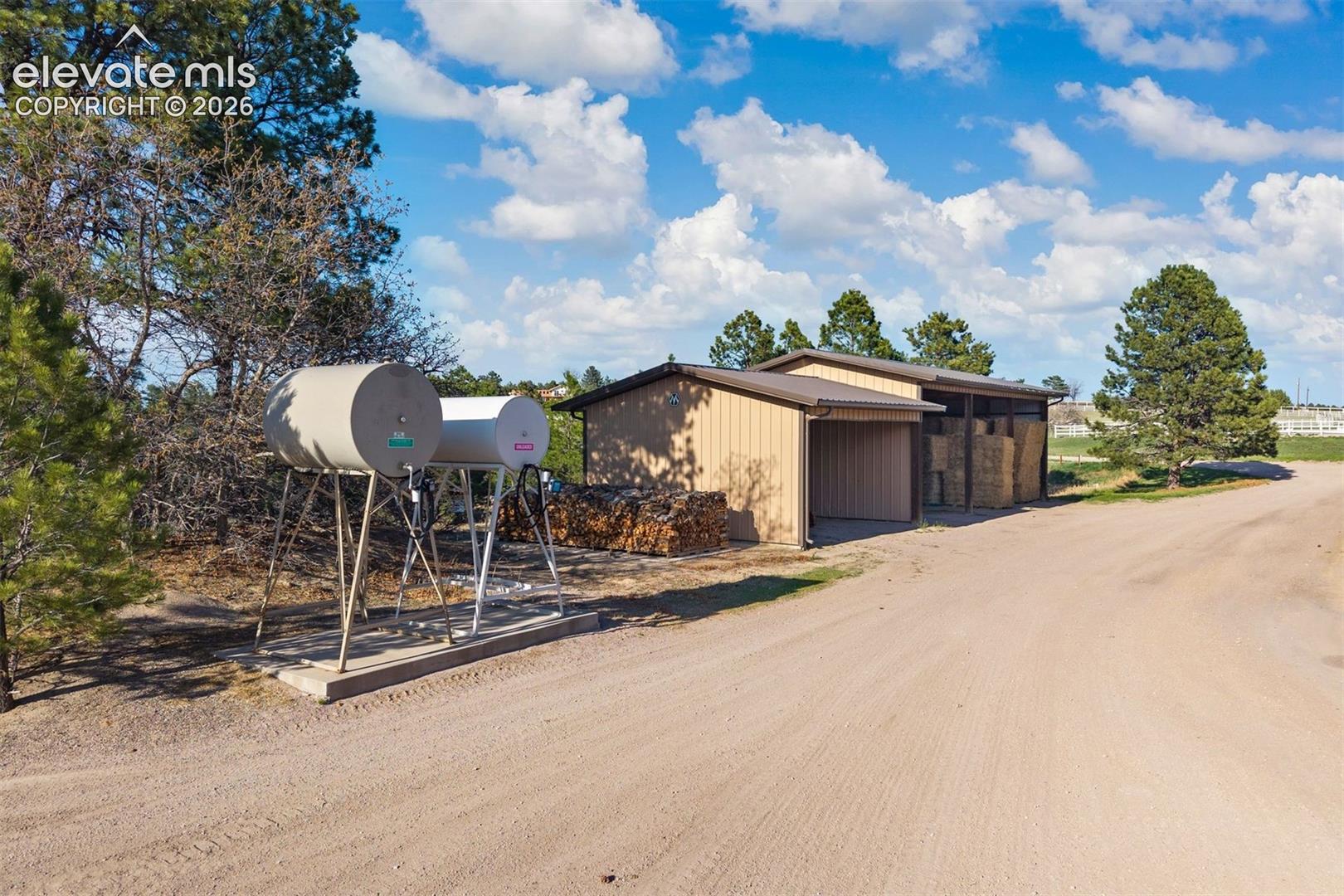 Two equipment and hay storage buildings, strategically positioned across the property, and two fuel tanks. 