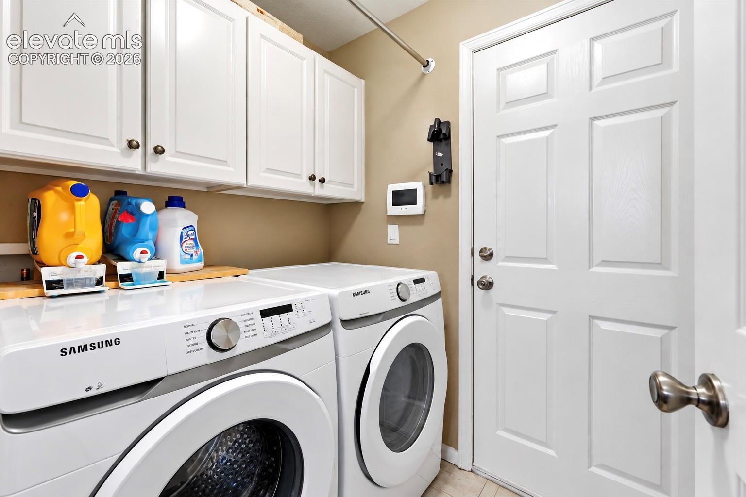 Dedicated laundry space and upper cabinetry add practical storage to the home's everyday routine.