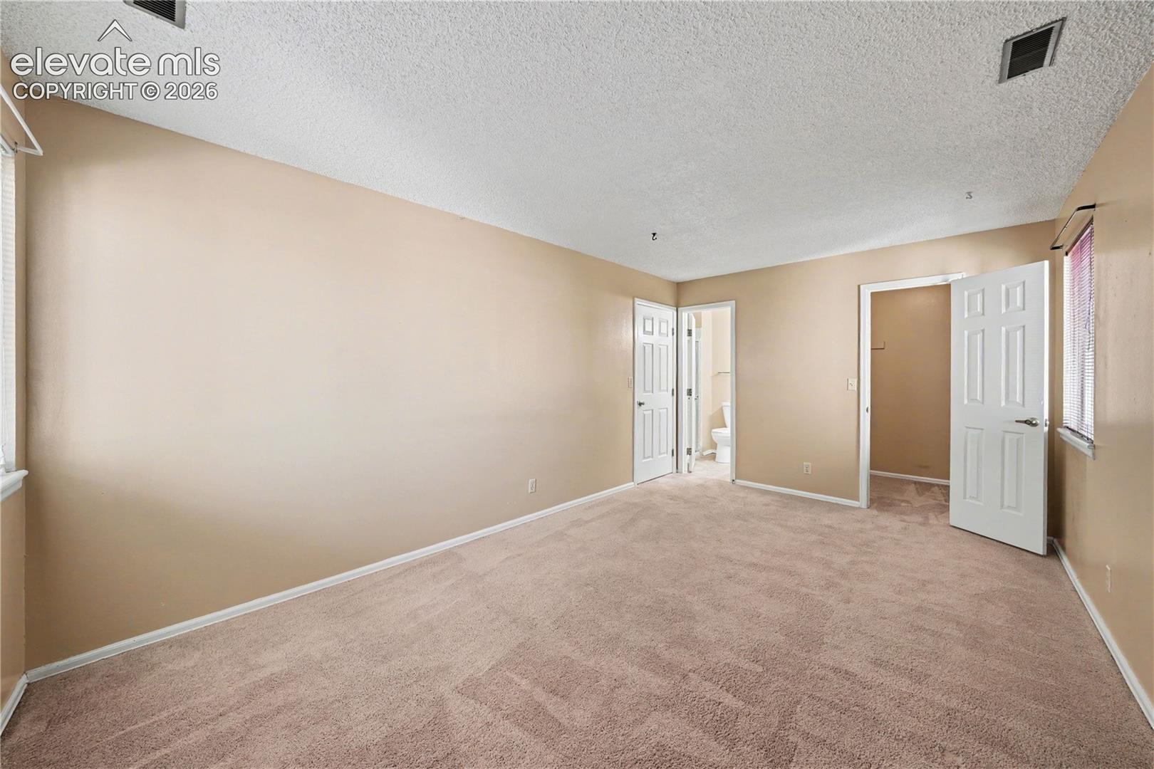 Bedroom with carpeted floors and ceiling fan