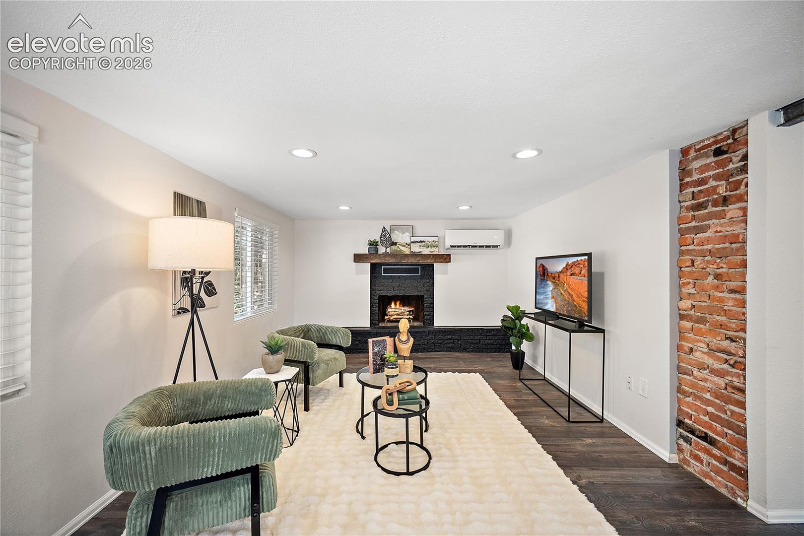Living space featuring dark wood-finish flooring, recessed lighting, and white walls