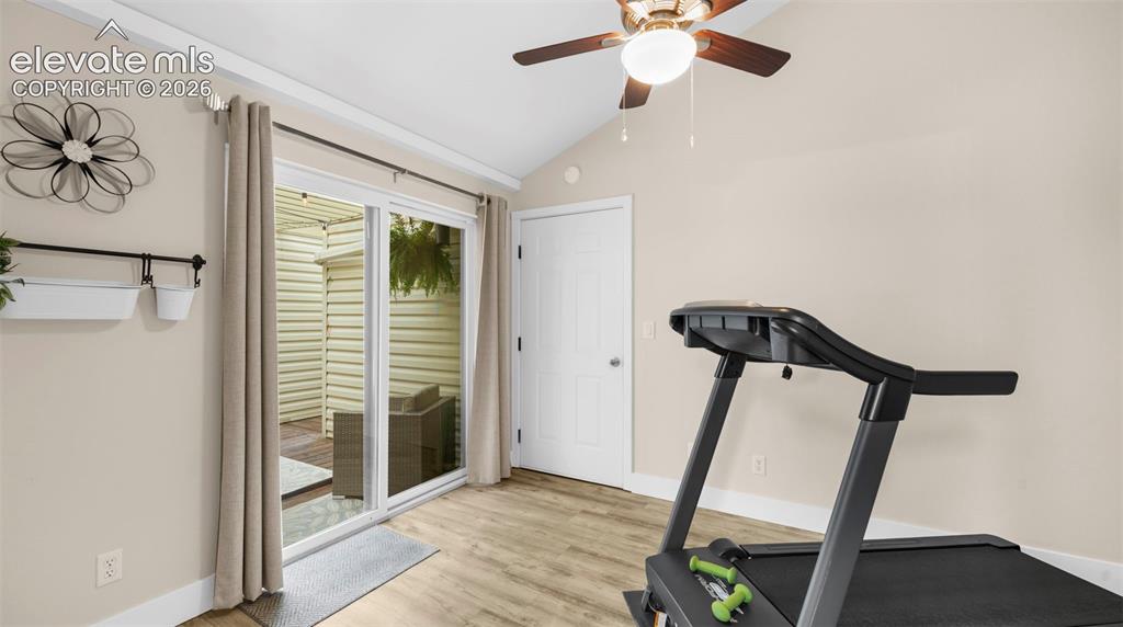 Sliding glass door opening to an outdoor patio with wood-finish flooring