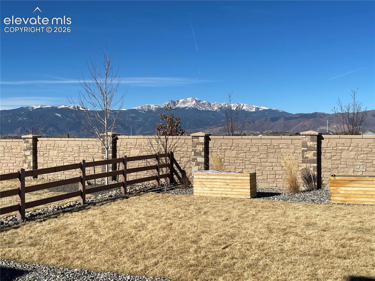 Fenced backyard featuring a mountain view