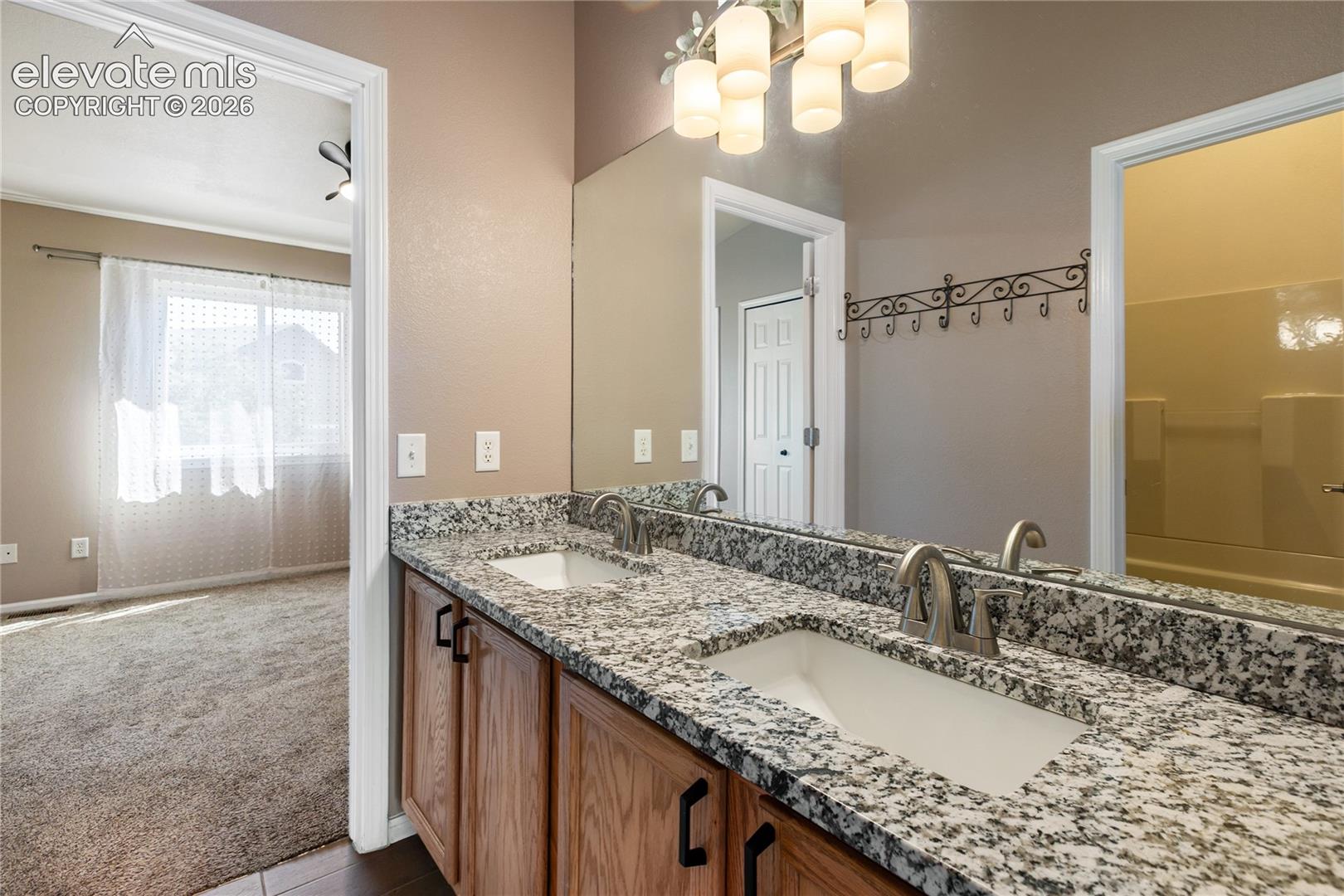 Double vanity, natural light, new granite countertop upstairs bathroom.