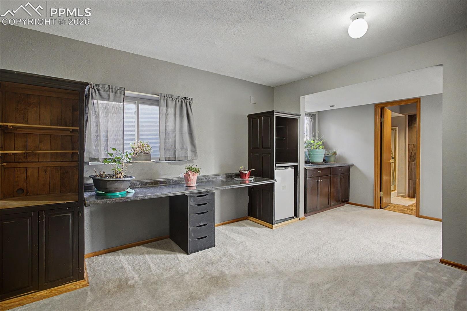 Basement office area with built-in desk.