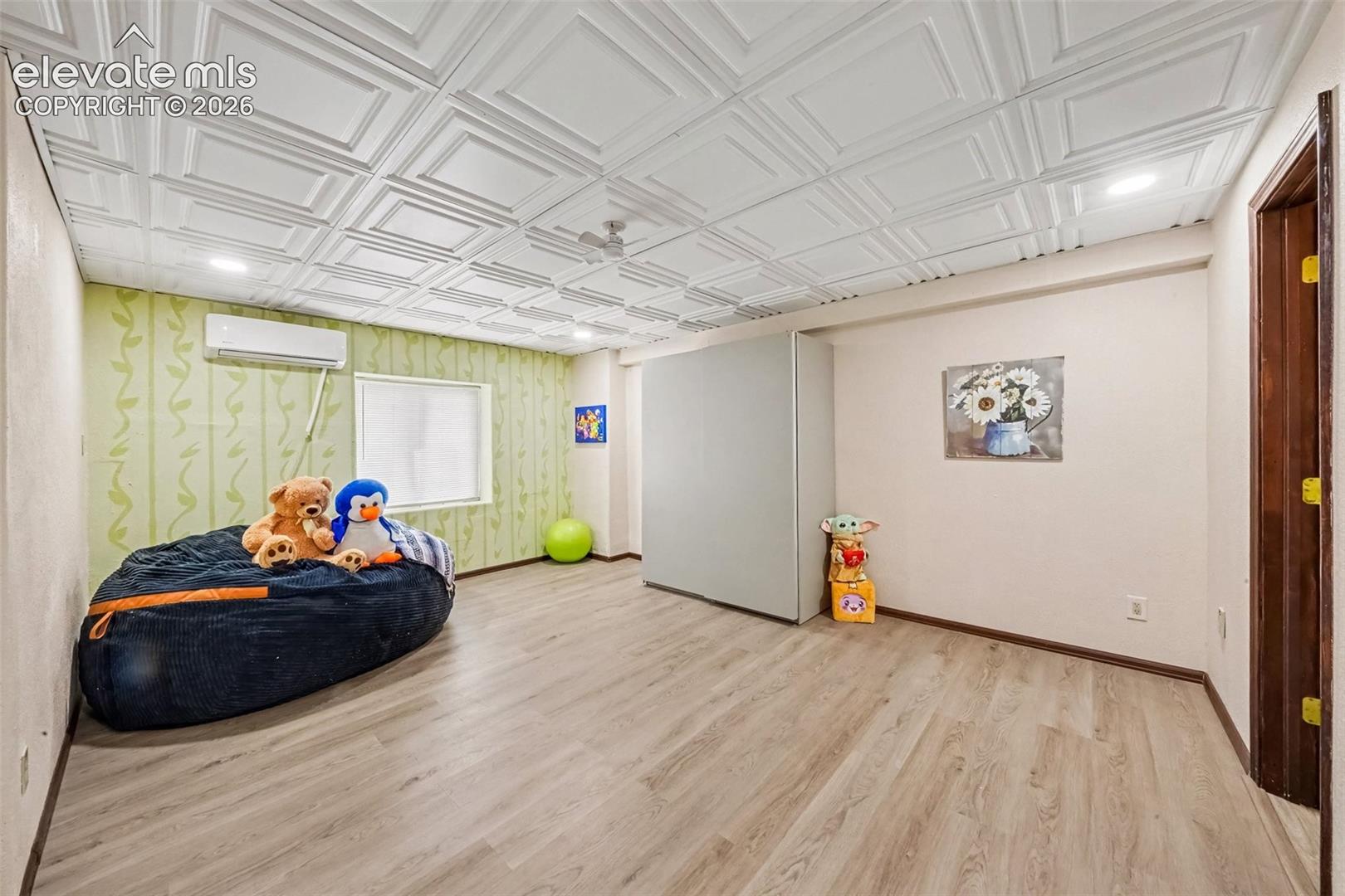 Spacious basement bedroom featuring durable LVT flooring and convenient access to a Jack-and-Jill bathroom, making it ideal for guests, family members, or flexible living arrangements