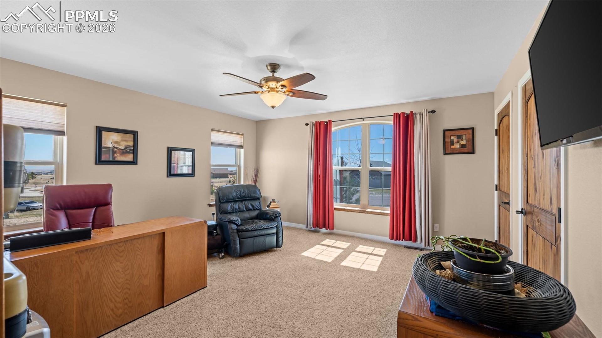 Bedroom currently being used as an office, healthy amount of natural light, and ceiling fan and double closets