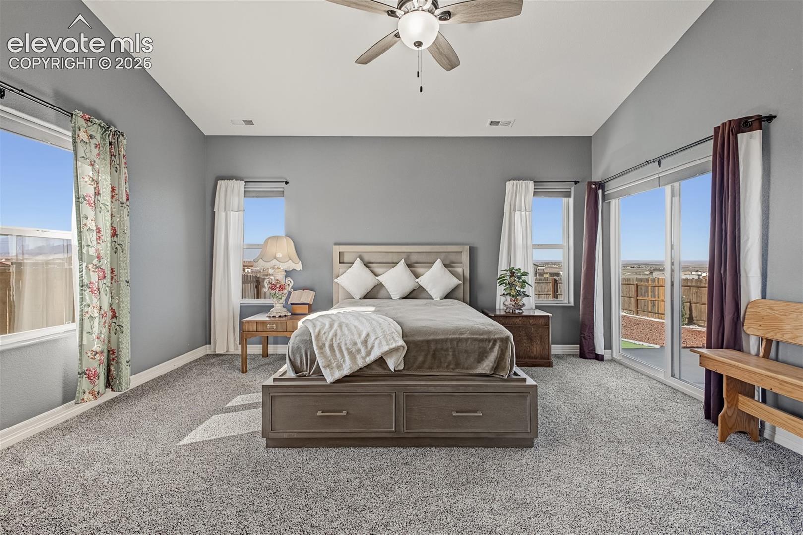 Your primary suite with mountain views, newer carpet, patio access and a spa-like primary bathroom with oversized walk-in closet.