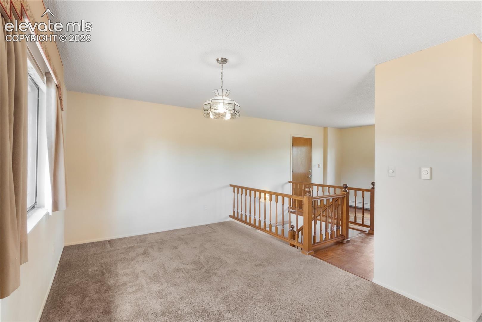 Dining area looking from living room, stairs to basement to the right