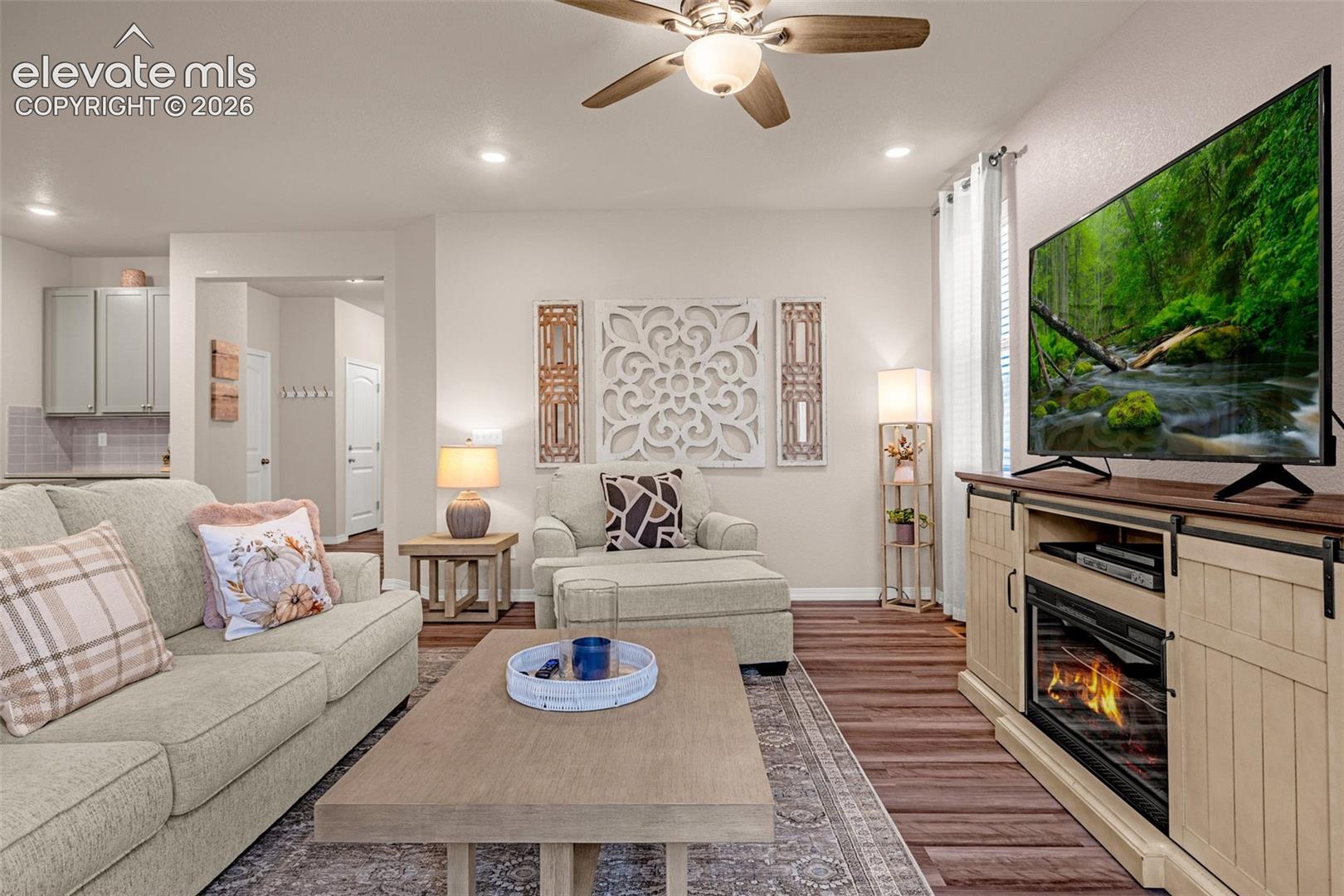 Recessed lighting, wood-finish flooring, ceiling fan, and light-toned walls