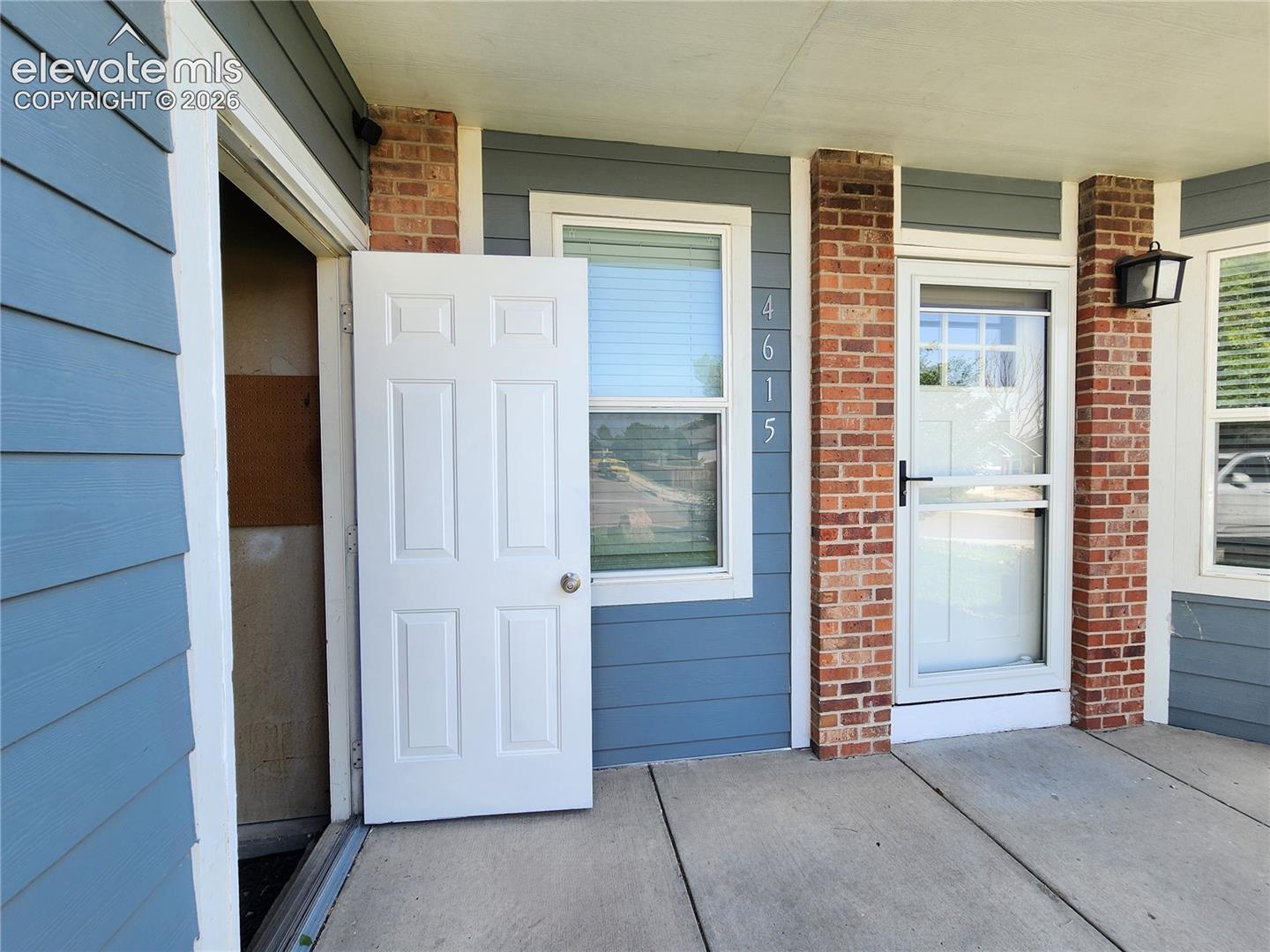 Convenient covered entry highlighting seamless access between the garage side door and the main front entrance