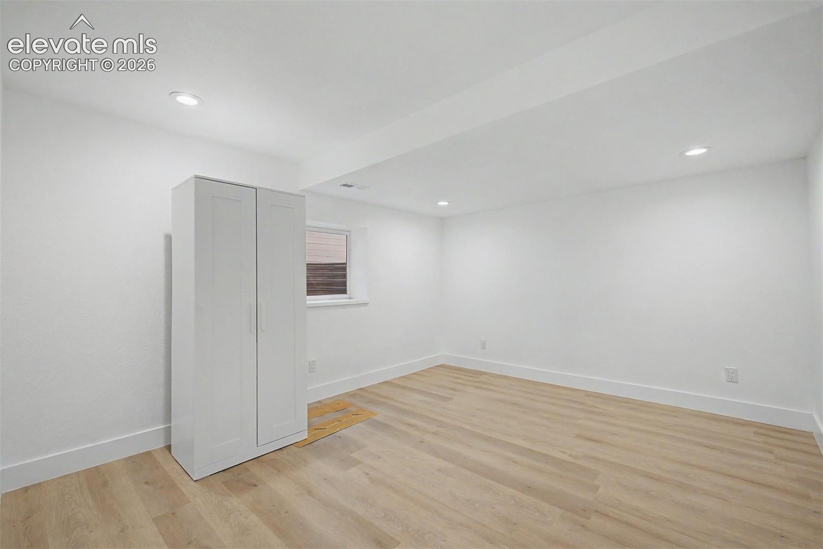 Basement bedroom with attached wardrobe 