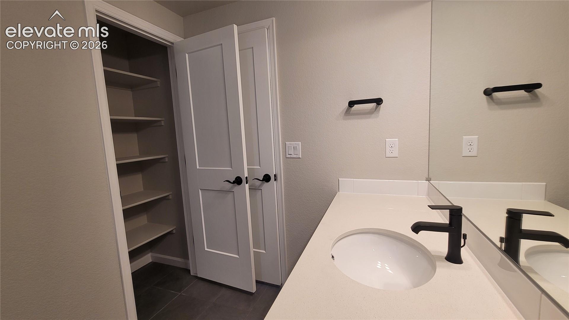 Full Bathroom with a linen closet, quartz countertops, and tile surrounds!