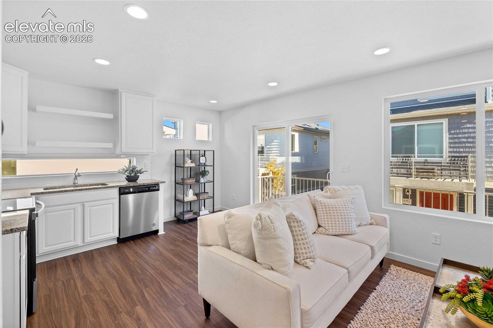 Open-concept living space with recessed lighting, wood-finish flooring, and white cabinetry
*photos of a model home*