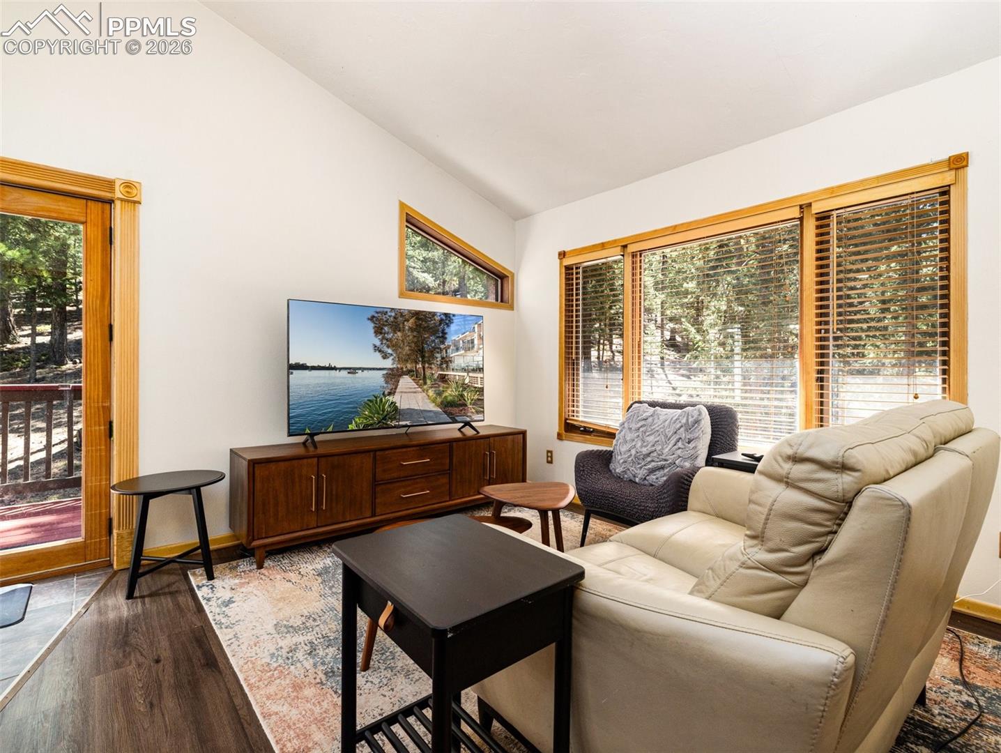 Living room featuring lofted ceiling and wood finished floors