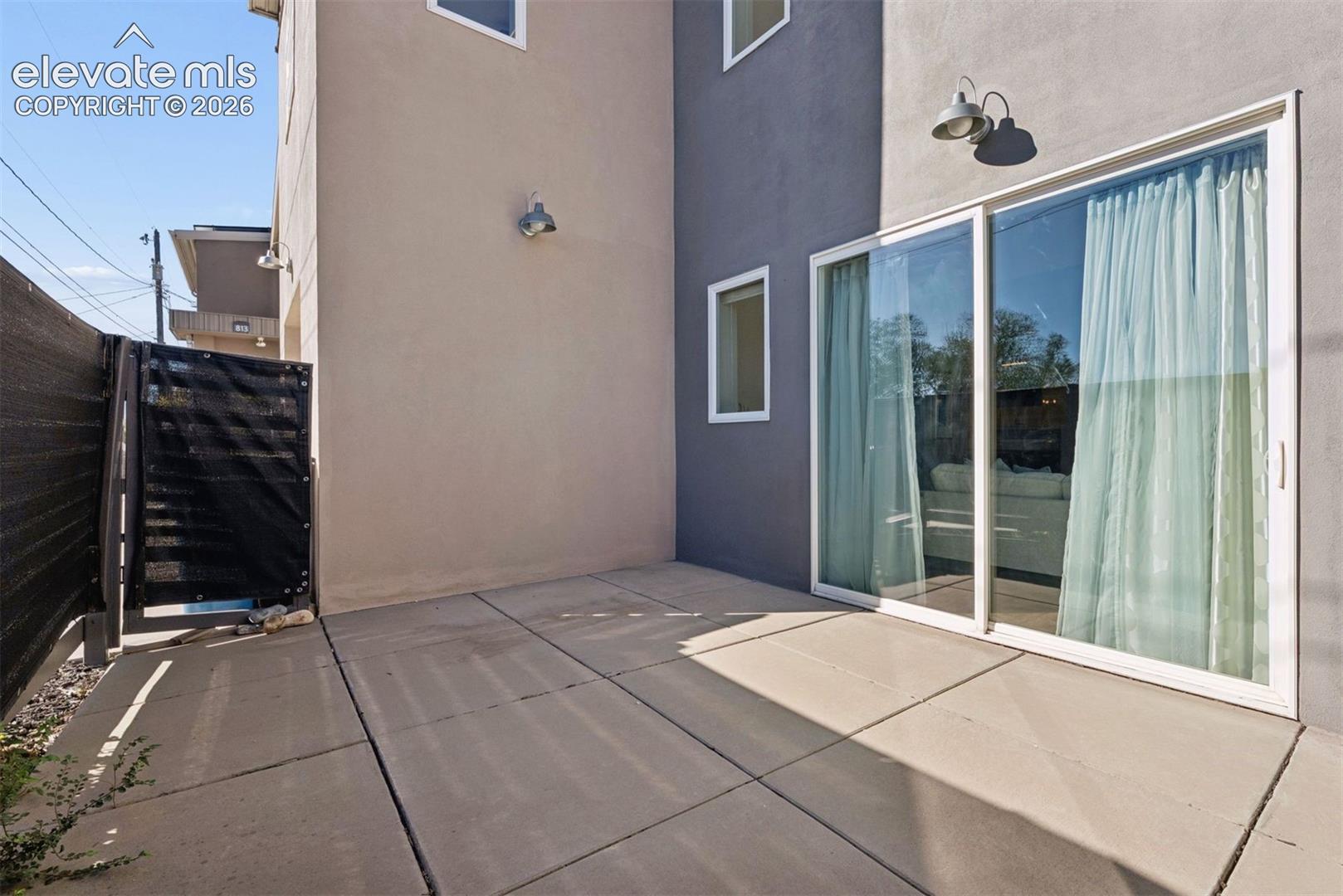 East side patio is fenced in for privacy and walks into the living room