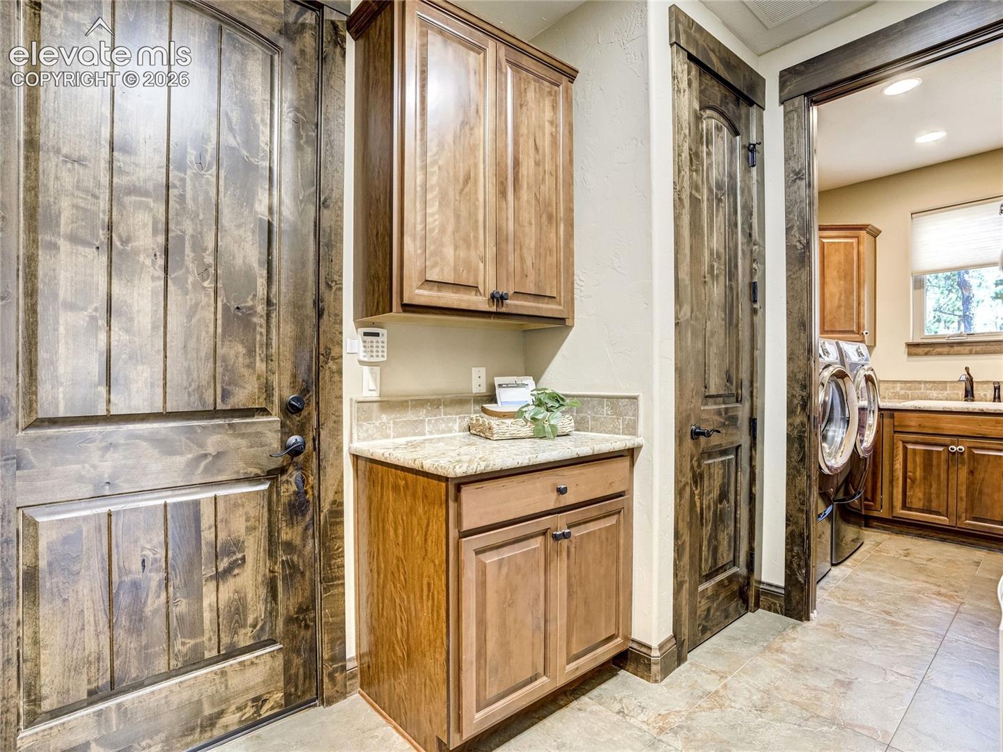A well-appointed mud room off of the four car garage flows effortlessly into the laundry - designed for flow and function.