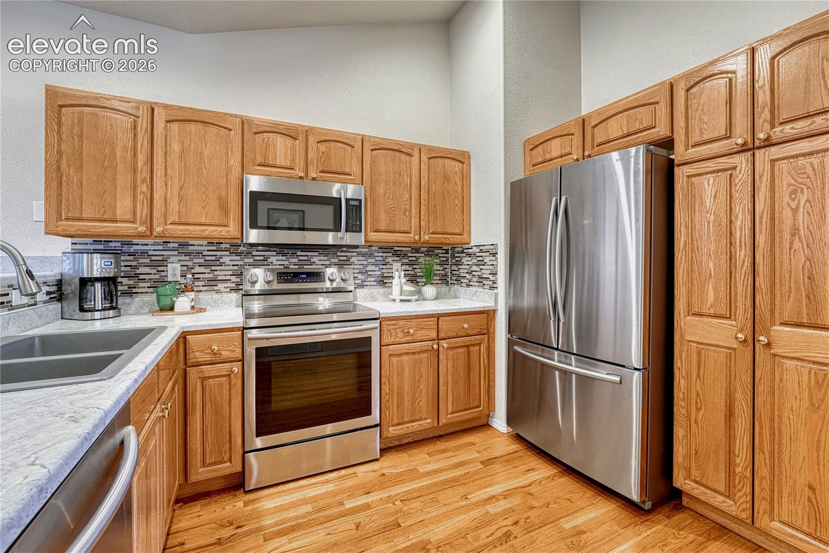 Cooking is a joy with an abundance of oak cabinet storage, durable laminate countertops, and all included Samsung stainless steel appliances
