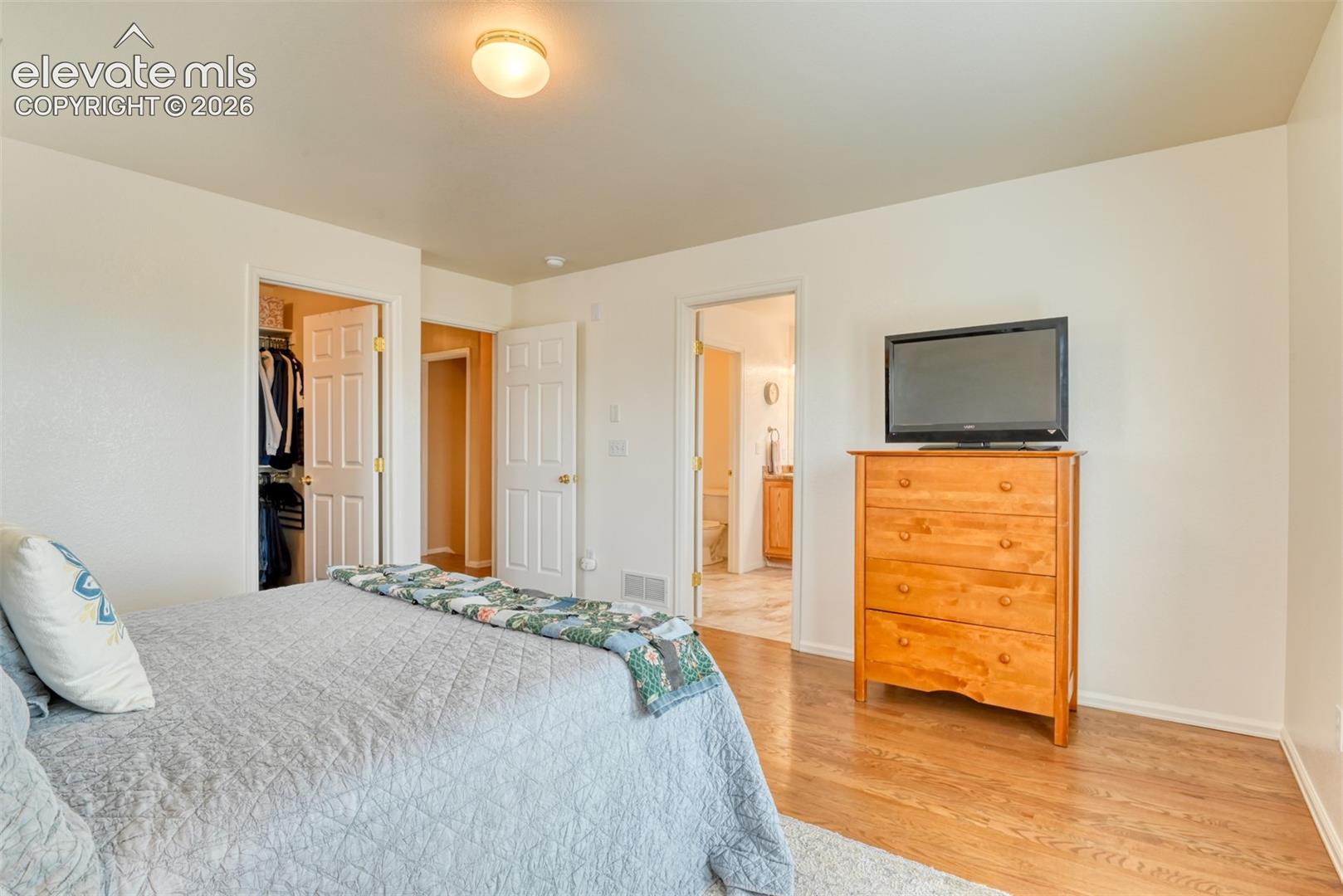Hardwood flooring, and white interior doors