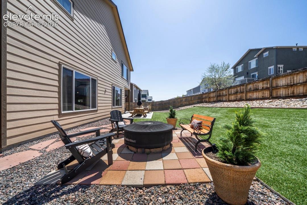 Backyard, astroturf, covered patio, firepit, flagstone walkway, storage shed