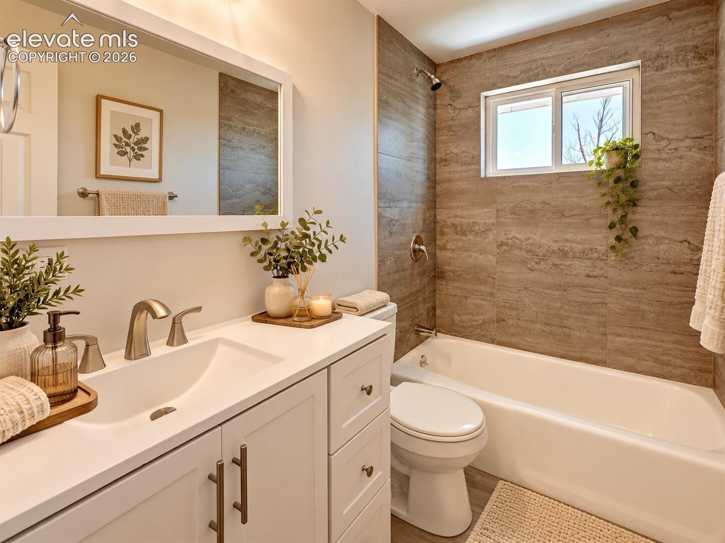 Bathroom featuring a white vanity cabinet with a quartz countertop, rectangular undermount sink, brushed nickel faucet, and a full-width mirror, complemented by a tub shower combination with floor-to-ceiling stone-patterned wall tile. AI-Enhanced – furniture/decor digitally added