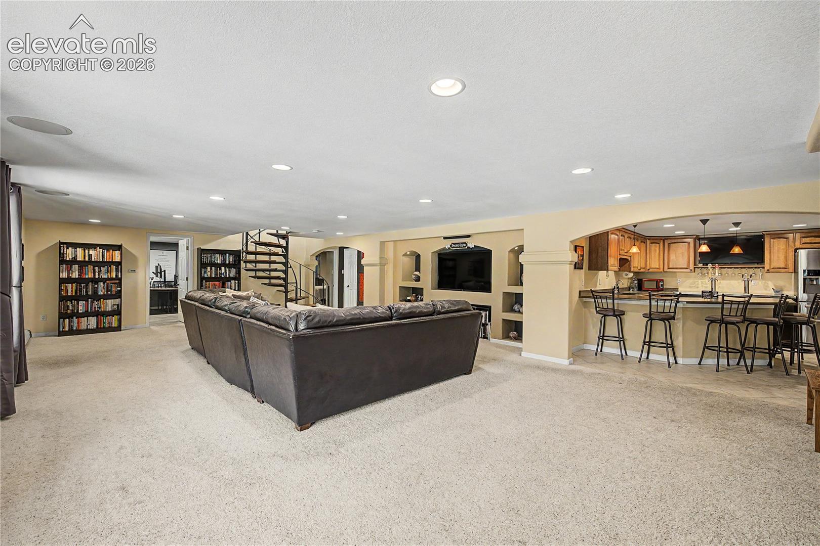 Just beyond the media area, a built-in wet bar extends the lower level into a true entertaining hub.