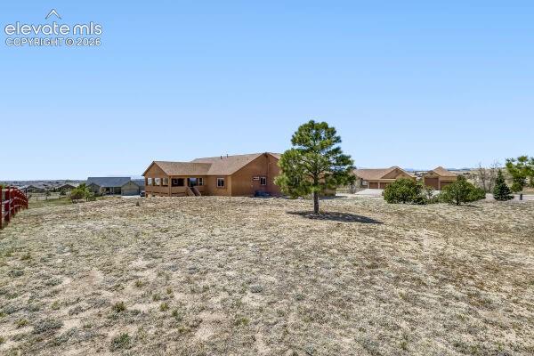Spacious property featuring a ranch-style residence with a covered porch, an attached two-car garage, and a detached two-car garage