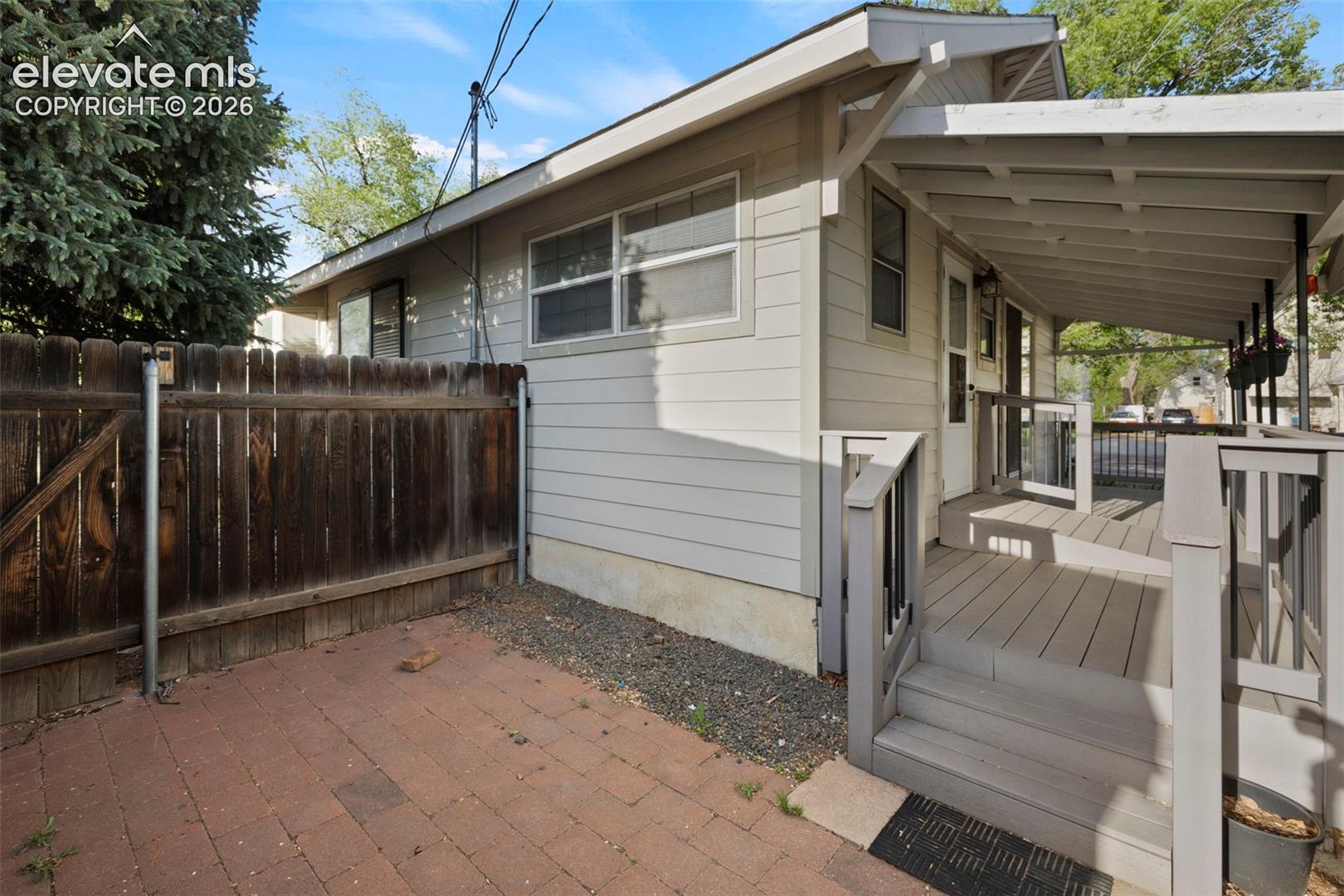 Covered porch with wood-finish decking and railing system