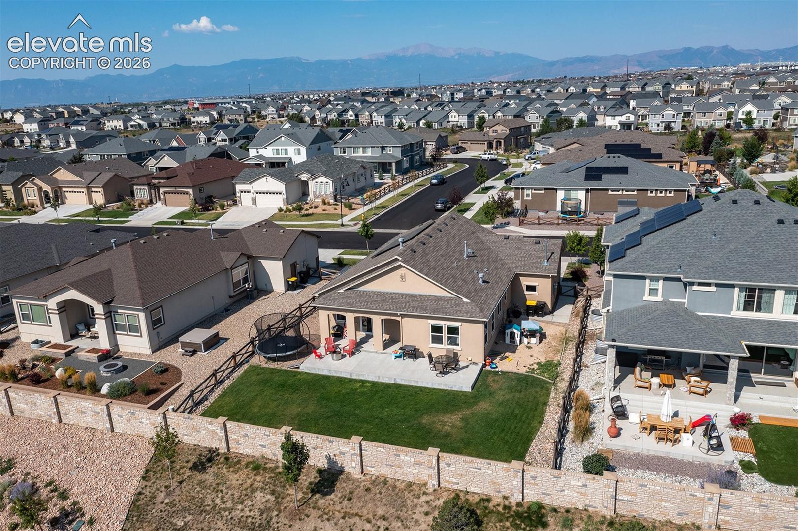 Expansive neighborhood featuring a mix of single-family homes with pitched roofs and attached garages