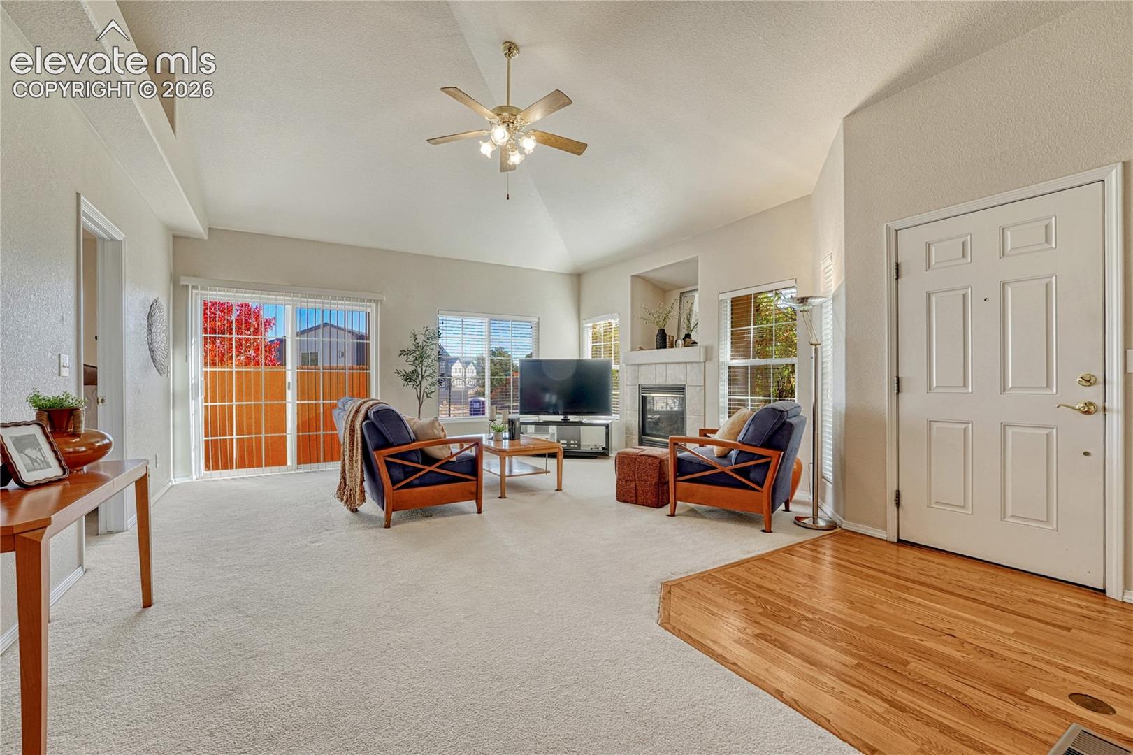 Step into the sunlit main-level great room boasting soaring vaulted ceilings, a warm gas fireplace, and a seamless flow out to your private patio. Hardwood flooring at the entry creates welcoming first impression
