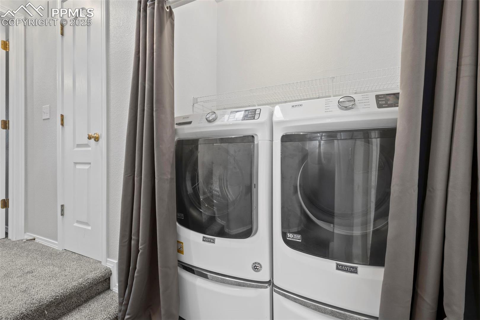Washroom featuring separate washer and dryer and carpet floors