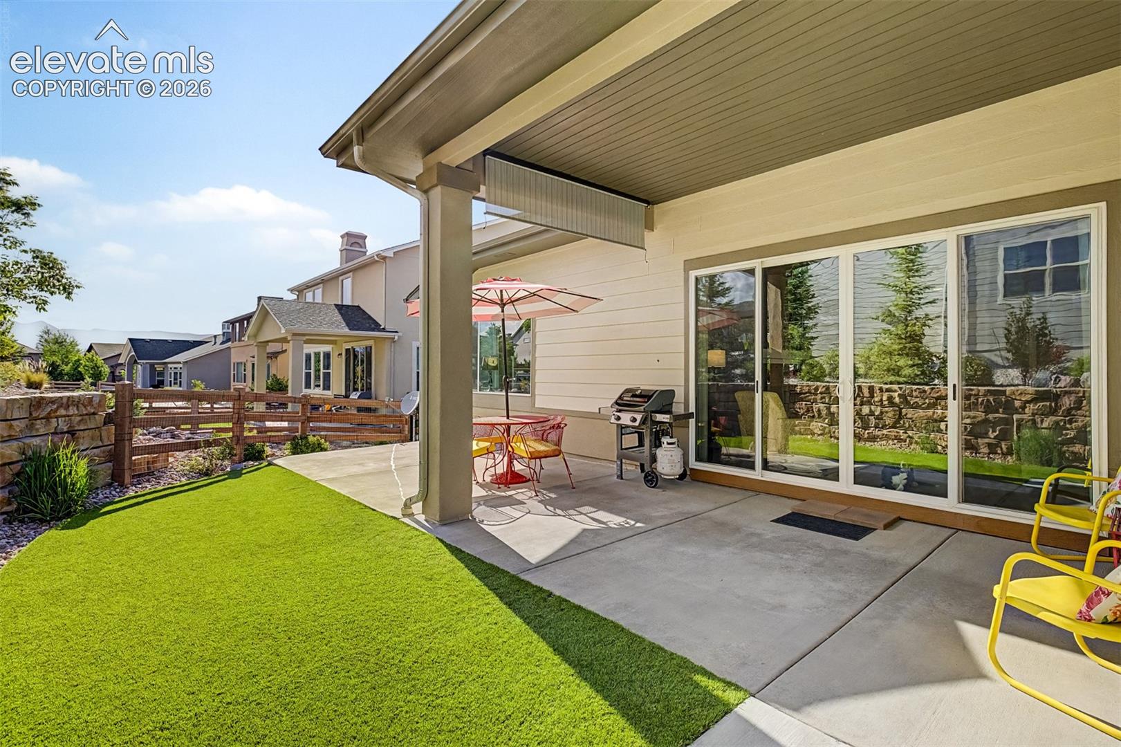 Covered patio positioned just off the living room extends the home’s living space outdoors, overlooking the beautifully landscaped backyard.