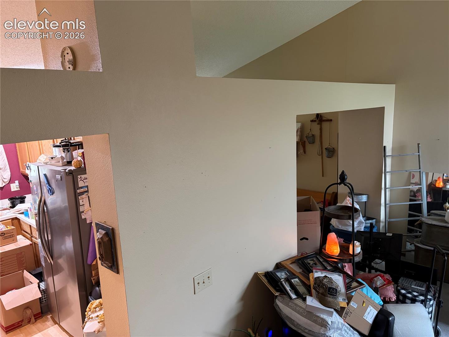 Vaulted ceilings featuring architectural cutouts and partial wall dividers