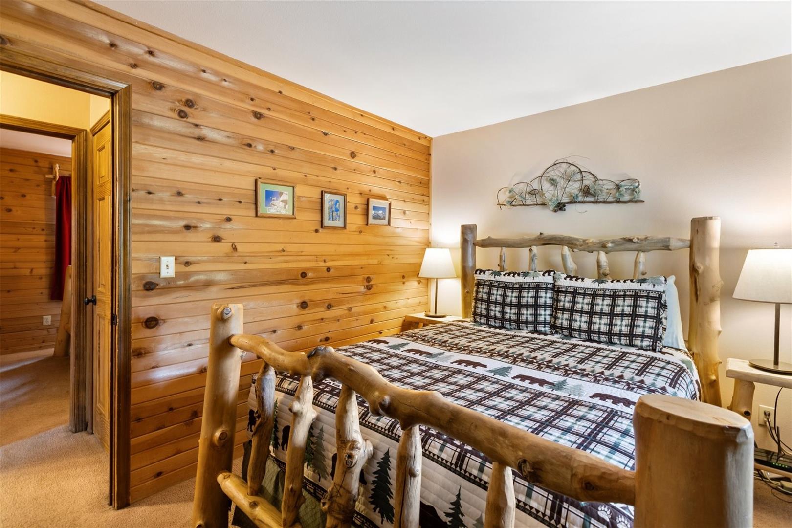 Wood paneling, carpeted flooring, and a solid core door
