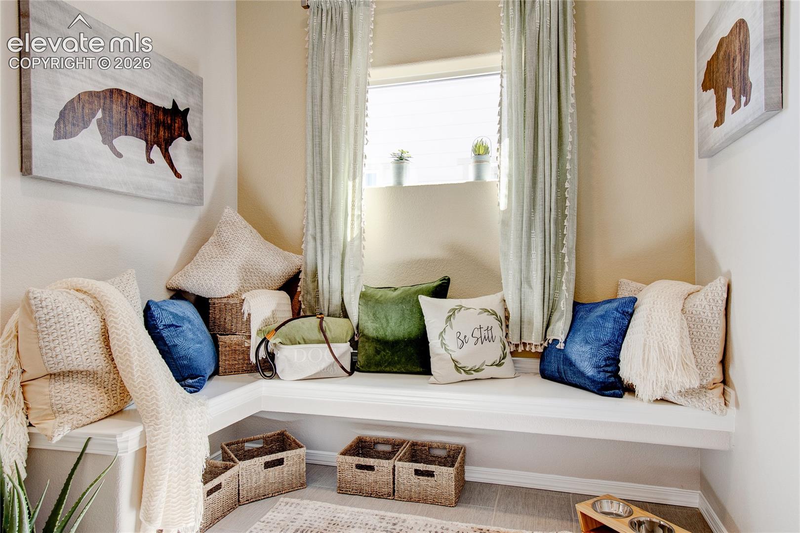 Built-in L-shaped bench seating with painted trim and tile flooring