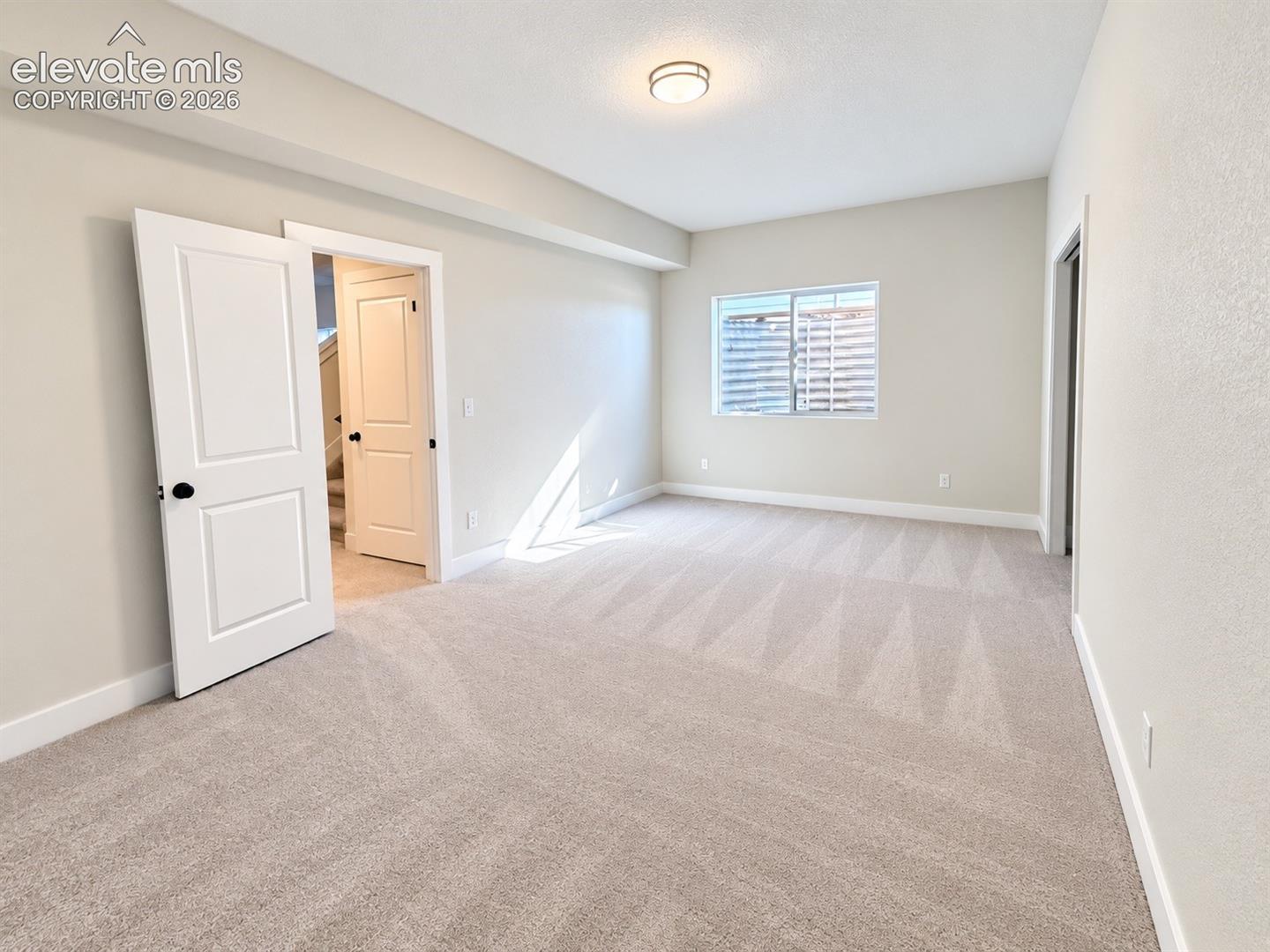 Neutral-toned walls and plush carpet flooring
